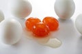 Three salted duck yolks and a pile of salted duck eggs