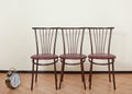 Three of the same chair against the wall Royalty Free Stock Photo