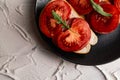 Three sandwiches with fresh and bright red tomatoes and smoked sausage, decorated with a leaf of green arugula Royalty Free Stock Photo