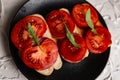 Three sandwiches with fresh and bright red tomatoes and smoked sausage, decorated with a leaf of green arugula Royalty Free Stock Photo