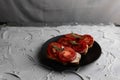 Three sandwiches with fresh and bright red tomatoes and smoked sausage, decorated with a leaf of green arugula Royalty Free Stock Photo