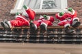 Three Santa dolls hanging on a balcony