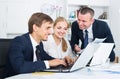 Three satisfied coworkers different sexes working in company office Royalty Free Stock Photo