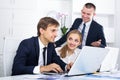 Three satisfied coworkers working in company office Royalty Free Stock Photo