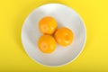 Three Satsumas on a Plate Royalty Free Stock Photo