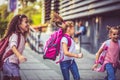 Cheerfully day. Three school girls outside