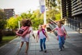 I will catch you. Three school girls outside. Focus is on background