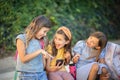 Three school girls using smart phone together