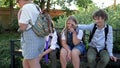 Three schoolchildren taunt their classmate. School bullying.