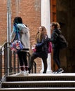 Three schoolgirls on the narrow street of Venice