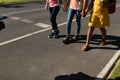 Three schoolgirls walking along a road to elementary school