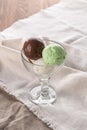 Three scoops of chocolate, pistachio and vanilla ice cream in glass bowl on white napkin Royalty Free Stock Photo