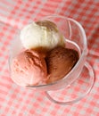 Three scoops of chocolate, strawberry and vanilla ice cream in g Royalty Free Stock Photo