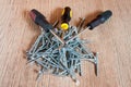 Three screwdrivers on a pile of screws Royalty Free Stock Photo