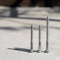 Three screws on a concrete surface Royalty Free Stock Photo