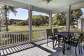 Three season screen porch with view out onto golf course and park