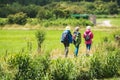 Three senior women walking on road in countryside.