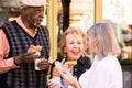 Three Seniors Eating Donuts Outdoors