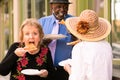 Three Seniors Eating Street Food
