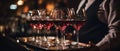 three servers hold wine glasses on a platter while waiting for orders Royalty Free Stock Photo