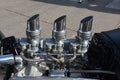 Three sets of carburetors on a car engine