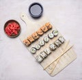 Three sets of sushi on a white vintage cutting board with ginger and soy sauce on wooden rustic background top view close up