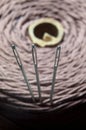 Three sewing needles are inserted into a spool of thread. close-up. Royalty Free Stock Photo