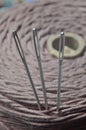 Three sewing needles are inserted into a spool of thread. close-up. Royalty Free Stock Photo
