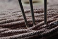 Three sewing needles are inserted into a spool of thread. close-up. Royalty Free Stock Photo