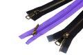 Three sewing zippers, two black and one lilac color