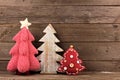 Three shabby chic Christmas trees against wood Royalty Free Stock Photo