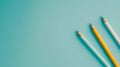 Three sharpened pencils on a soft light blue backdrop