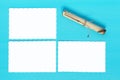 Three sheets of paper and a scroll on a blue background Royalty Free Stock Photo