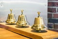Three shiny golden vintage bells