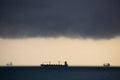 Three ships at sea in very cloudy weathe Royalty Free Stock Photo