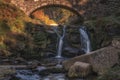 Three Shire Heads. An autumnal waterfall and stone packhorse bridge at Three Shires Head in the Peak District Royalty Free Stock Photo
