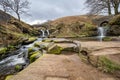 Three Shire Heads. A waterfall and packhorse stone bridge at Three Shires Head in the Peak District National Park Royalty Free Stock Photo