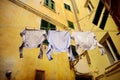 Three shirts drying on a rope in Riomaggiore, the largest of the five centuries-old villages of Cinque Terre, Italian Riviera,