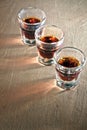 Three shot glasses full of dark colored alcohol Royalty Free Stock Photo