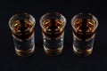 Three shots with cognac or jager on black Royalty Free Stock Photo