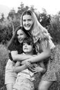 Three siblings hugging in a garden Royalty Free Stock Photo