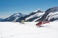 Three sightseeing helicopters standing on top of Aletsch glacier