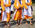 three sikh men with orange clothes during religious ceremony Royalty Free Stock Photo