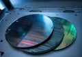 Three silicon wafers showcasing intricate patterns and reflections Royalty Free Stock Photo