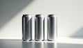 Three silver aluminium beverage cans arranged on clean, minimalistic background. Soft natural light casts subtle shadows, shiny Royalty Free Stock Photo