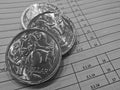 Three silver coins of Australian dollars on invoice sheet Royalty Free Stock Photo