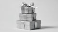 Silver-wrapped gift boxes stacked in a pyramid on a light gray background with copy space Royalty Free Stock Photo