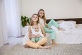 Three sisters on the bed in the bedroom in the morning Royalty Free Stock Photo