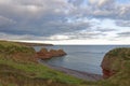 The Three Sisters cliffs stretching out into the North Sea from Cove Haven Bay on the Arbroath Coastal Footpath Royalty Free Stock Photo