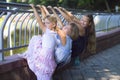 Three sisters hang on the railing